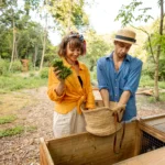 couple throwing cut grass to compost wooden bin 2023 11 27 04 52 33 utc